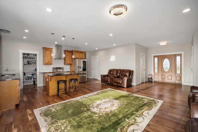 living area with dark wood-style floors, baseboards, and recessed lighting