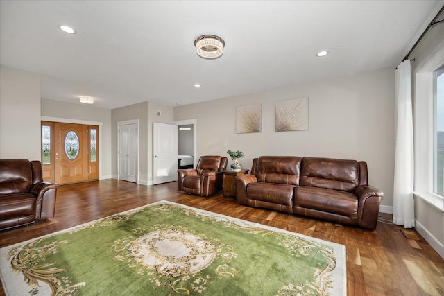 living room featuring recessed lighting, baseboards, and wood finished floors