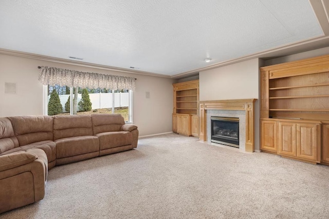 living area with ornamental molding, light carpet, a textured ceiling, a tile fireplace, and baseboards