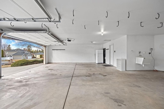 garage with freestanding refrigerator