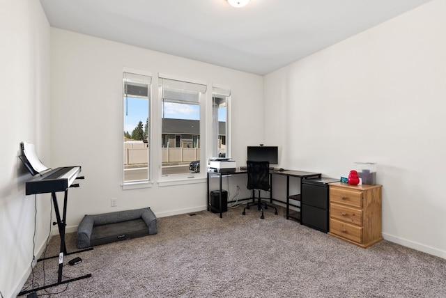 carpeted office featuring baseboards