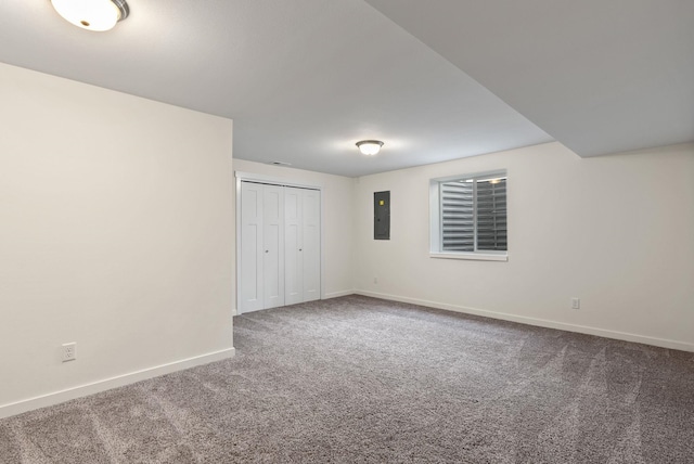 unfurnished bedroom featuring a closet, carpet, electric panel, and baseboards