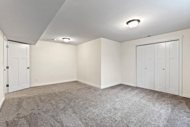 unfurnished bedroom featuring carpet, a closet, visible vents, and baseboards