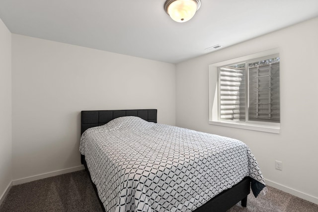 bedroom featuring carpet floors, visible vents, and baseboards