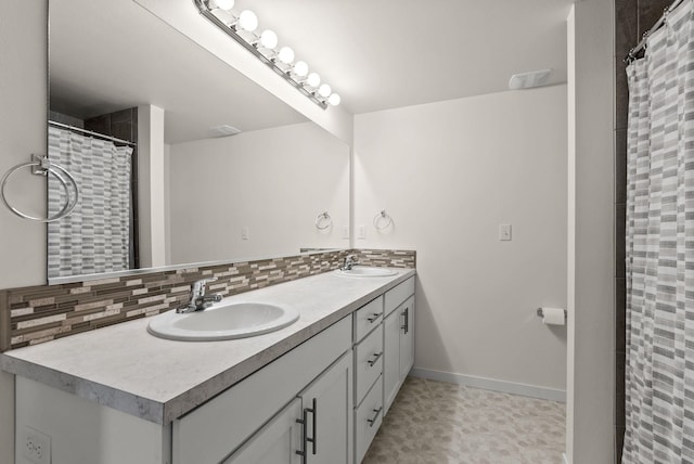 bathroom featuring a sink, backsplash, a shower with shower curtain, and double vanity