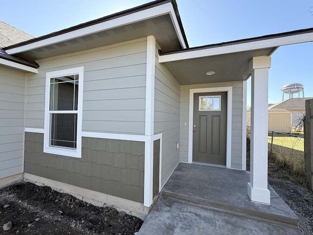 doorway to property featuring fence