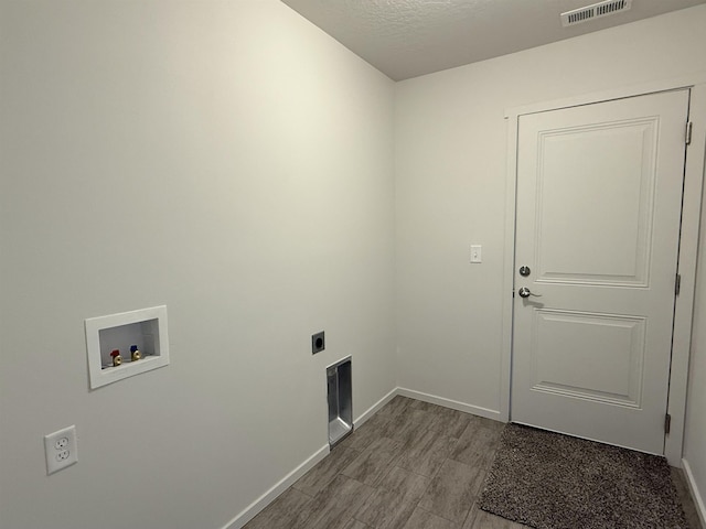 laundry area with washer hookup, visible vents, electric dryer hookup, laundry area, and baseboards