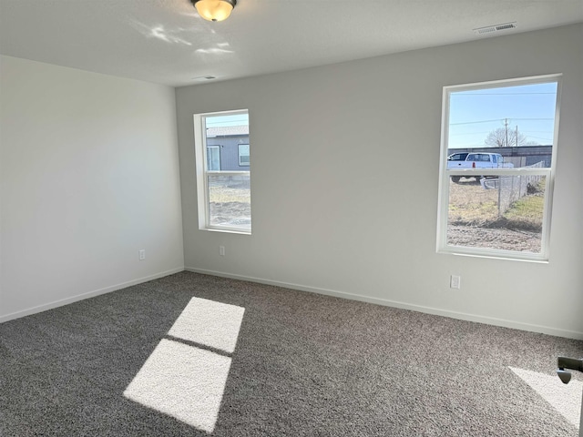 carpeted empty room with baseboards and visible vents