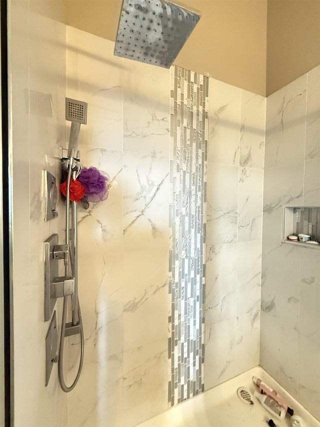 full bathroom with a marble finish shower