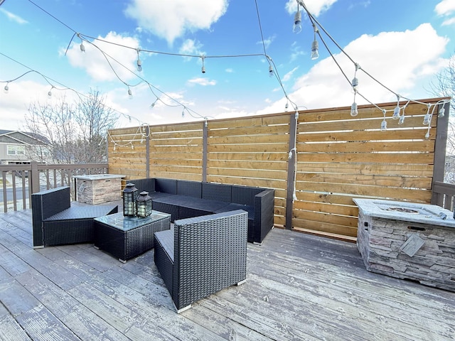 deck with an outdoor hangout area and fence