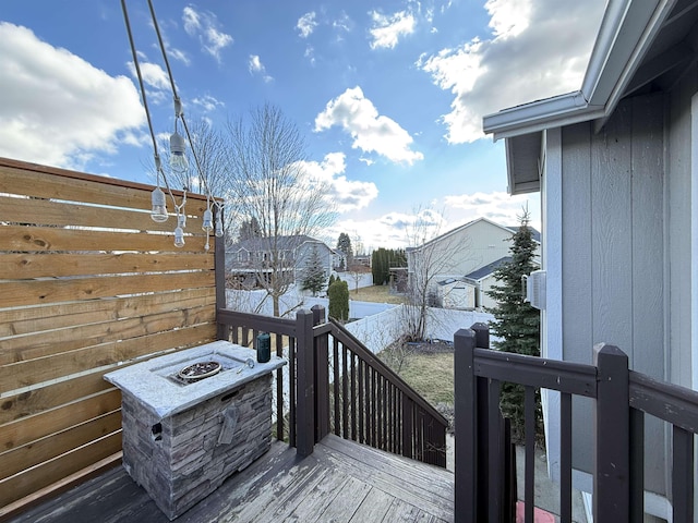 deck featuring an outdoor fire pit and a fenced backyard