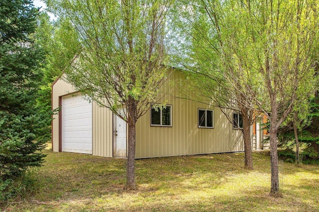 view of property exterior featuring an outbuilding and a yard