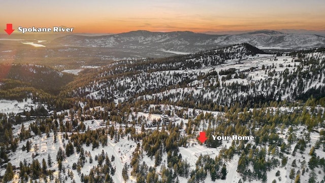 snowy aerial view with a mountain view