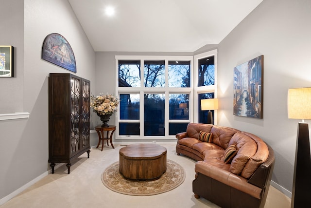 living room featuring carpet floors, high vaulted ceiling, and baseboards