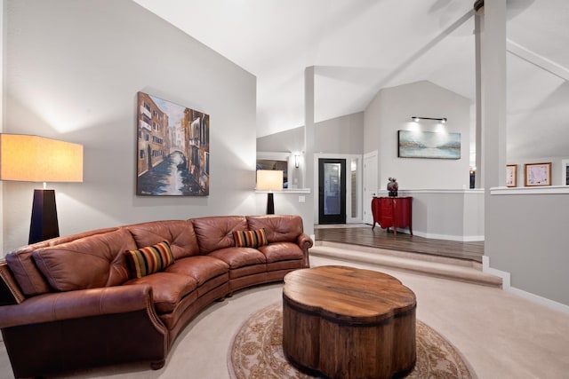 carpeted living room with lofted ceiling and baseboards