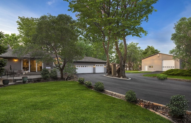 ranch-style house with a garage and a front yard