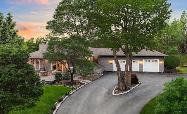 view of front of home with driveway and a chimney