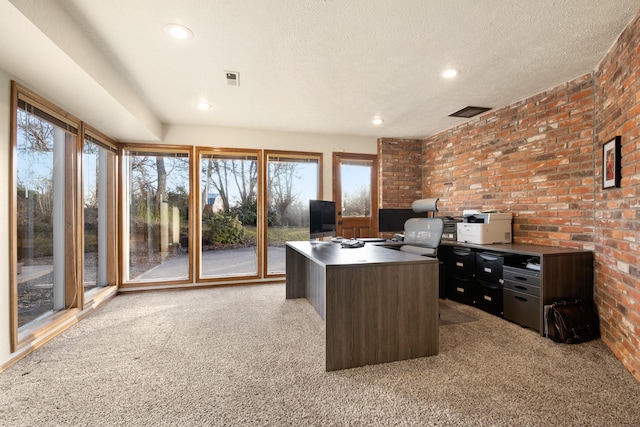 office space featuring recessed lighting, visible vents, light colored carpet, a textured ceiling, and brick wall