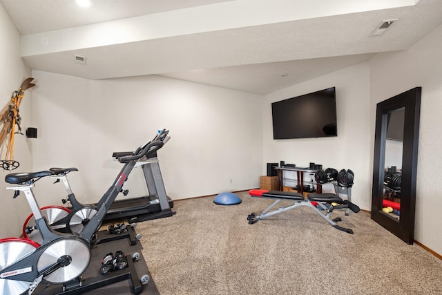 workout area with carpet flooring, visible vents, and baseboards