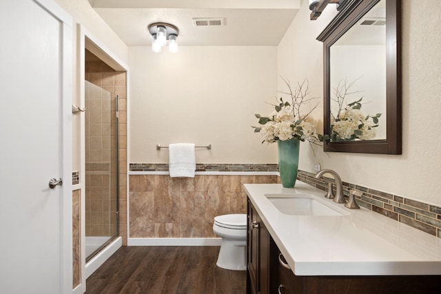 full bathroom with vanity, a stall shower, wood finished floors, and toilet