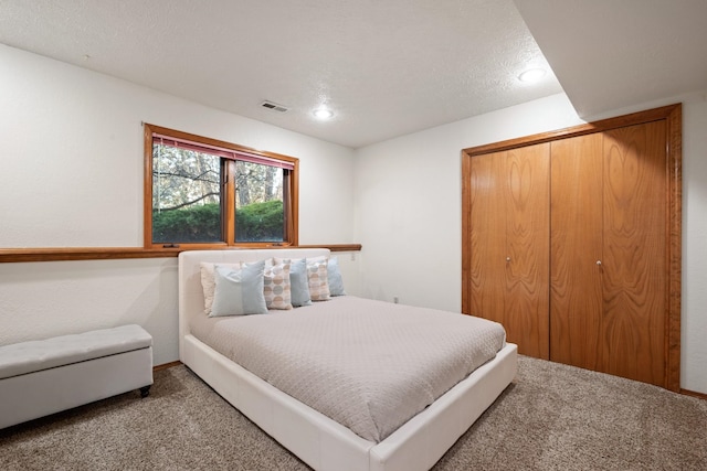 bedroom with carpet floors, a closet, and visible vents