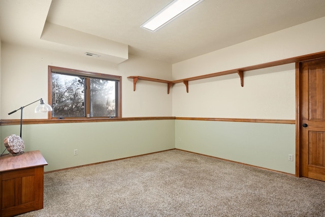 carpeted empty room featuring visible vents and baseboards