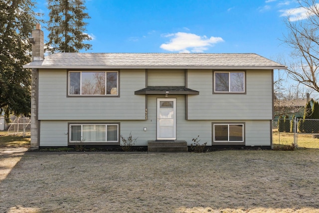 split foyer home with entry steps and fence