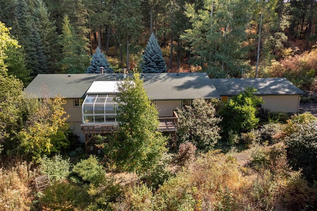 birds eye view of property with a wooded view