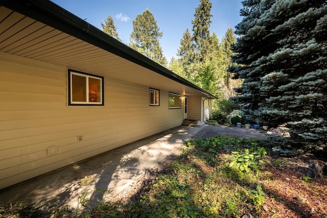 view of side of home with a patio area