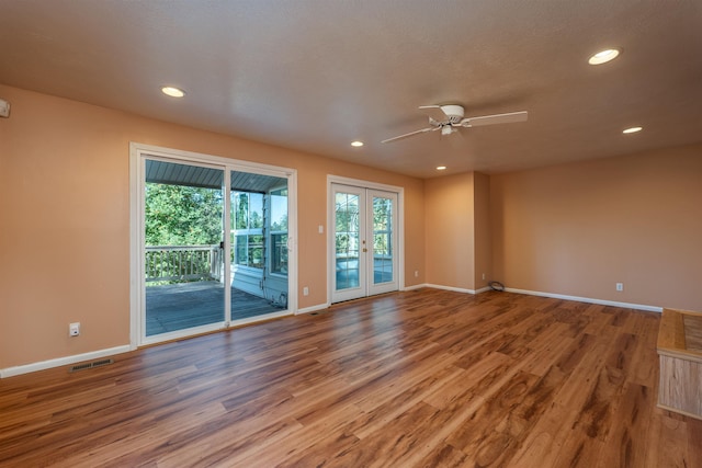 spare room with recessed lighting, french doors, visible vents, and wood finished floors