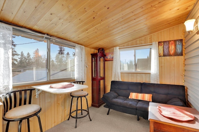 carpeted living room featuring wooden ceiling, vaulted ceiling, and wooden walls