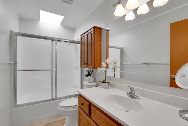 bathroom with toilet, visible vents, combined bath / shower with glass door, and vanity