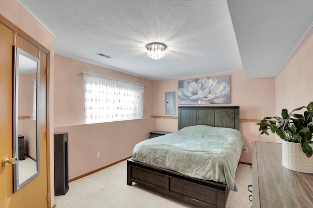 bedroom with electric panel, baseboards, visible vents, a textured ceiling, and carpet flooring