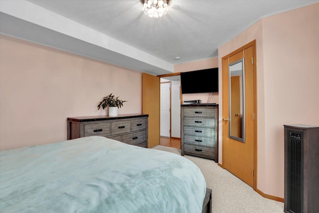 bedroom with light carpet and baseboards