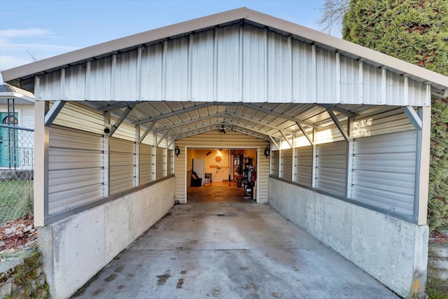 view of vehicle parking with a detached carport and fence