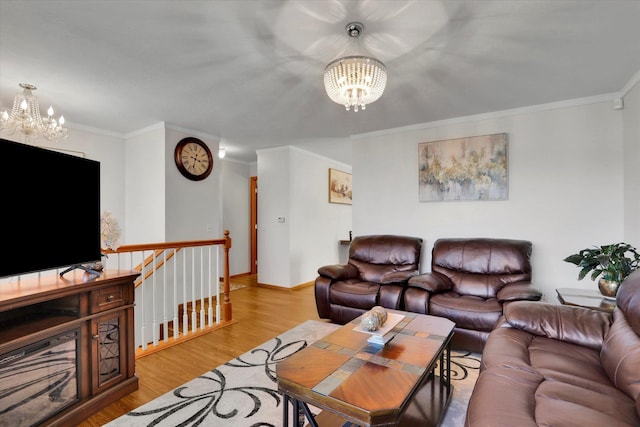 living room with crown molding, a notable chandelier, and wood finished floors