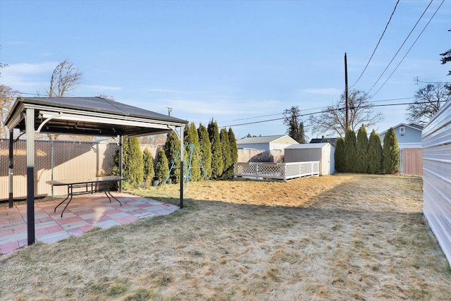 view of yard featuring a fenced backyard, an outdoor structure, a patio, and a gazebo