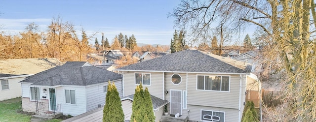 view of front of property with entry steps and a shingled roof