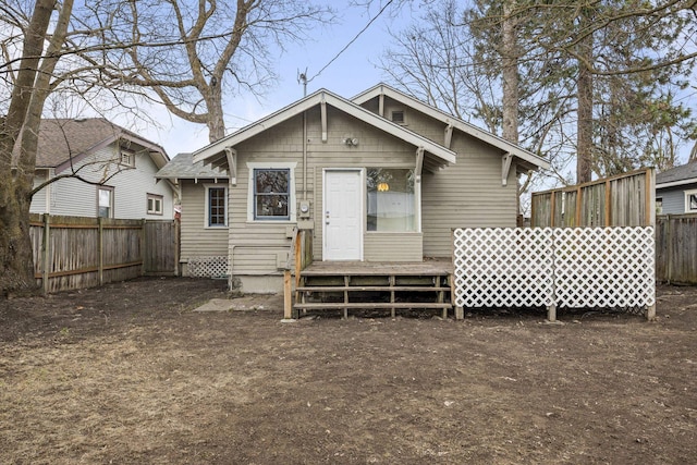 rear view of property featuring fence