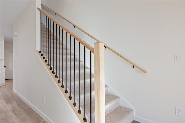 stairs with baseboards and wood finished floors