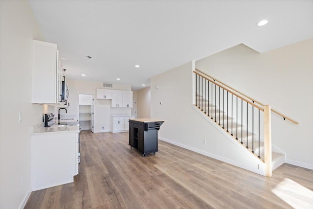 kitchen with light wood-style floors, visible vents, white cabinetry, and recessed lighting