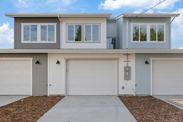 view of property with driveway and an attached garage