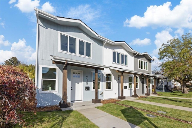 view of front facade featuring covered porch and a front yard