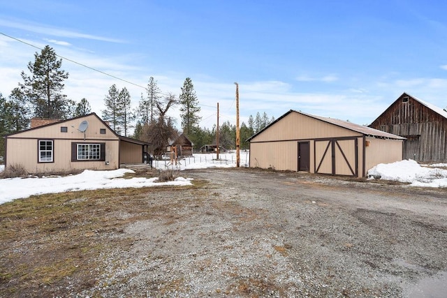 exterior space featuring an outbuilding, a detached garage, and a barn