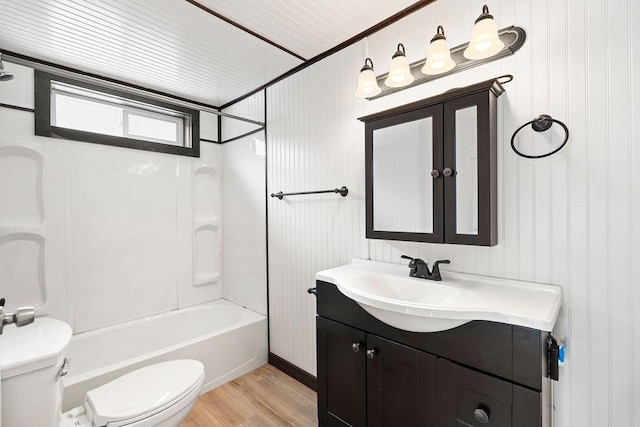 bathroom featuring wood finished floors, bathing tub / shower combination, vanity, and toilet