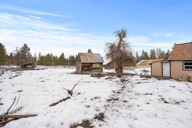 yard covered in snow featuring an outdoor structure