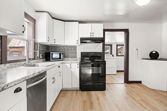 kitchen with washer / dryer, light wood-style floors, stainless steel appliances, under cabinet range hood, and a sink