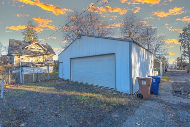 detached garage featuring fence