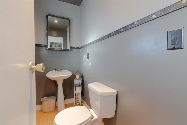 bathroom with toilet and baseboards