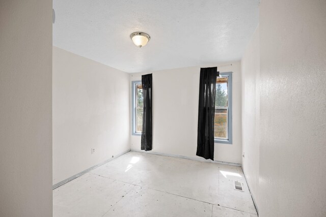 spare room featuring a healthy amount of sunlight and visible vents